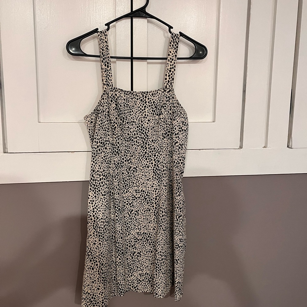 This is a “cheetah” print above the knee dress that fits true as a small